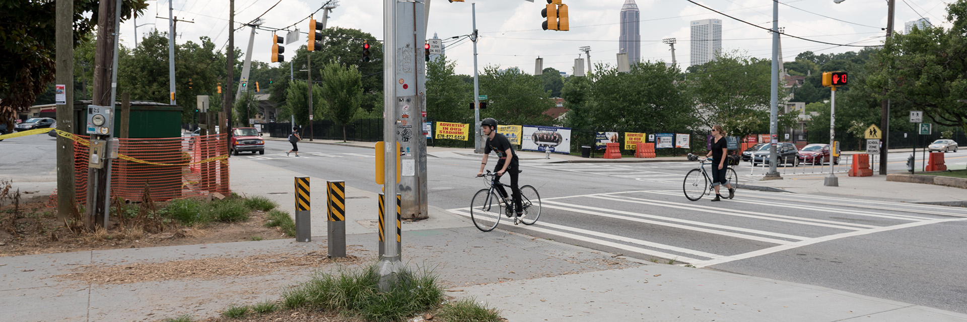 An image of cyclists crossing an urban intersection.